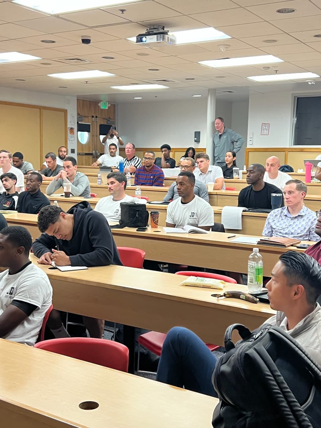 Officials taking notes during a JD80 classroom session